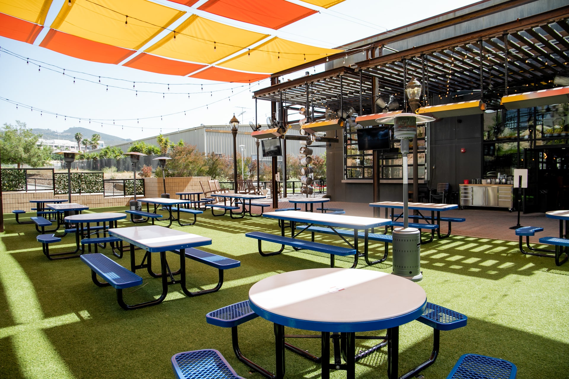 A vibrant outdoor dining space with string lights and shaded seating, creating the perfect setting for private events in San Marcos.